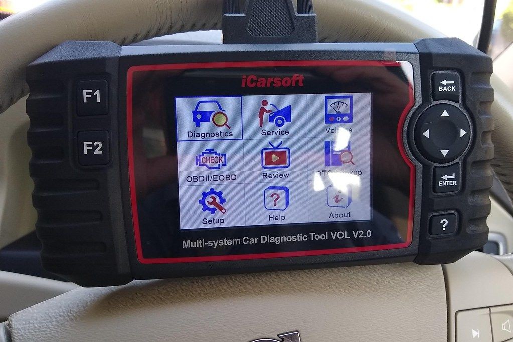 Close-up of an OBD2 scanner displaying live data readings during car diagnostics