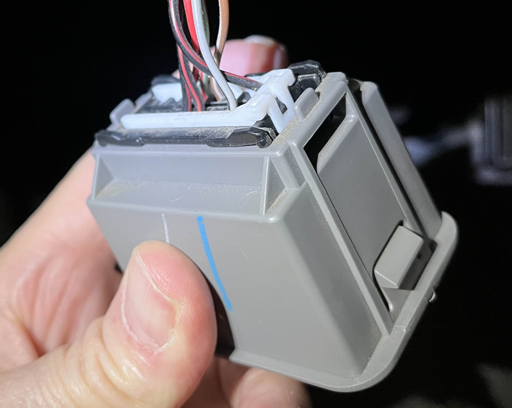 Back view of a 2001 Subaru Forester OBD2 port connector, showing the white clip for pin removal, similar to a 2017 Subaru WRX.