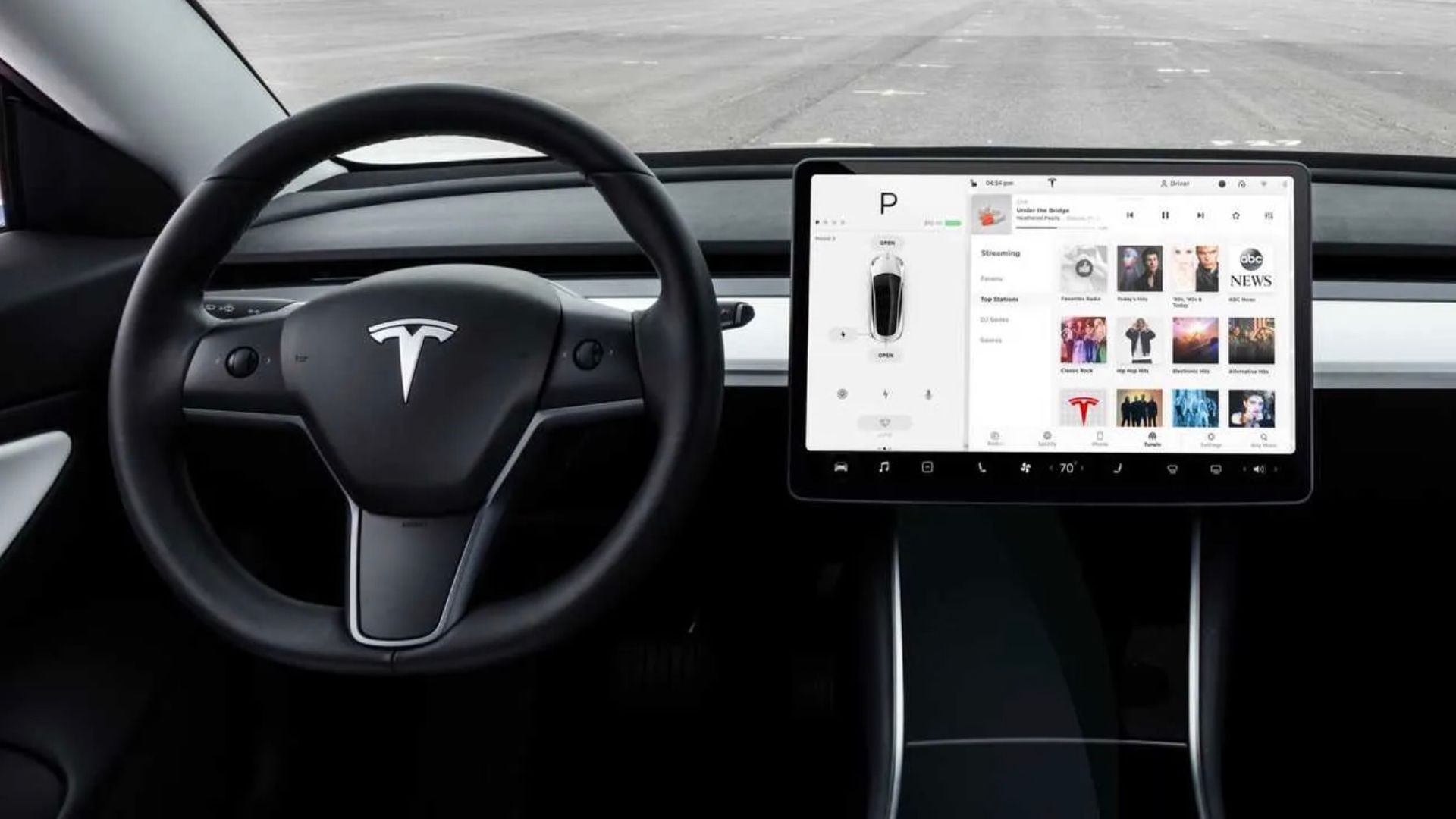 Tesla interior with a focus on the large display, suggesting the ability to access and utilize public WiFi networks while parked.