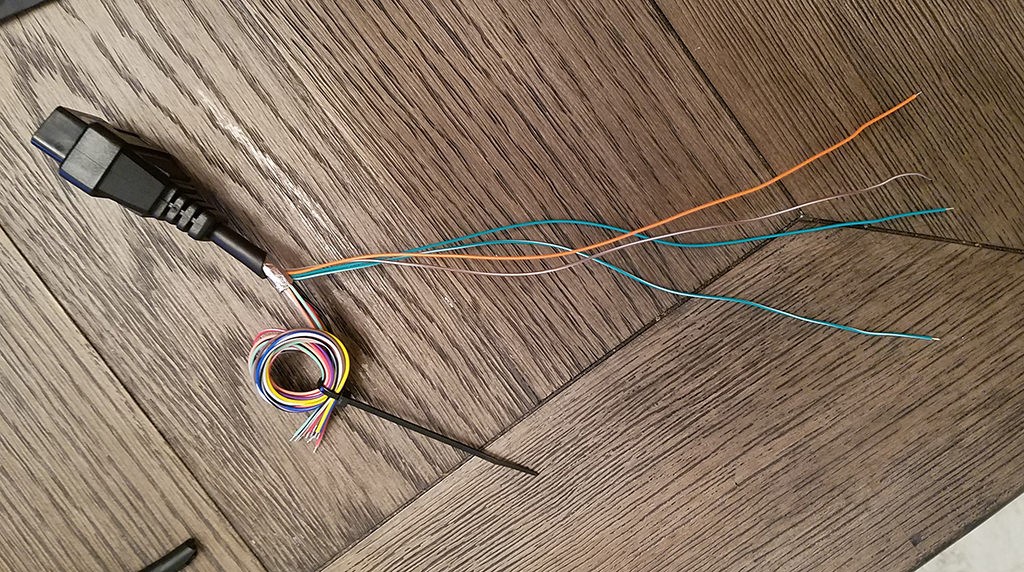 Four essential wires isolated from an OBD2 cable for creating a 4-pin diagnostic connector.