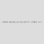 OBD2 Bluetooth Adapter being plugged into car's OBDII port