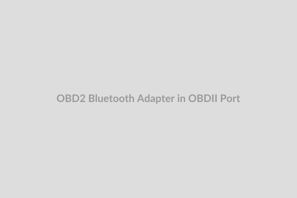 OBD2 Bluetooth Adapter being plugged into car's OBDII port